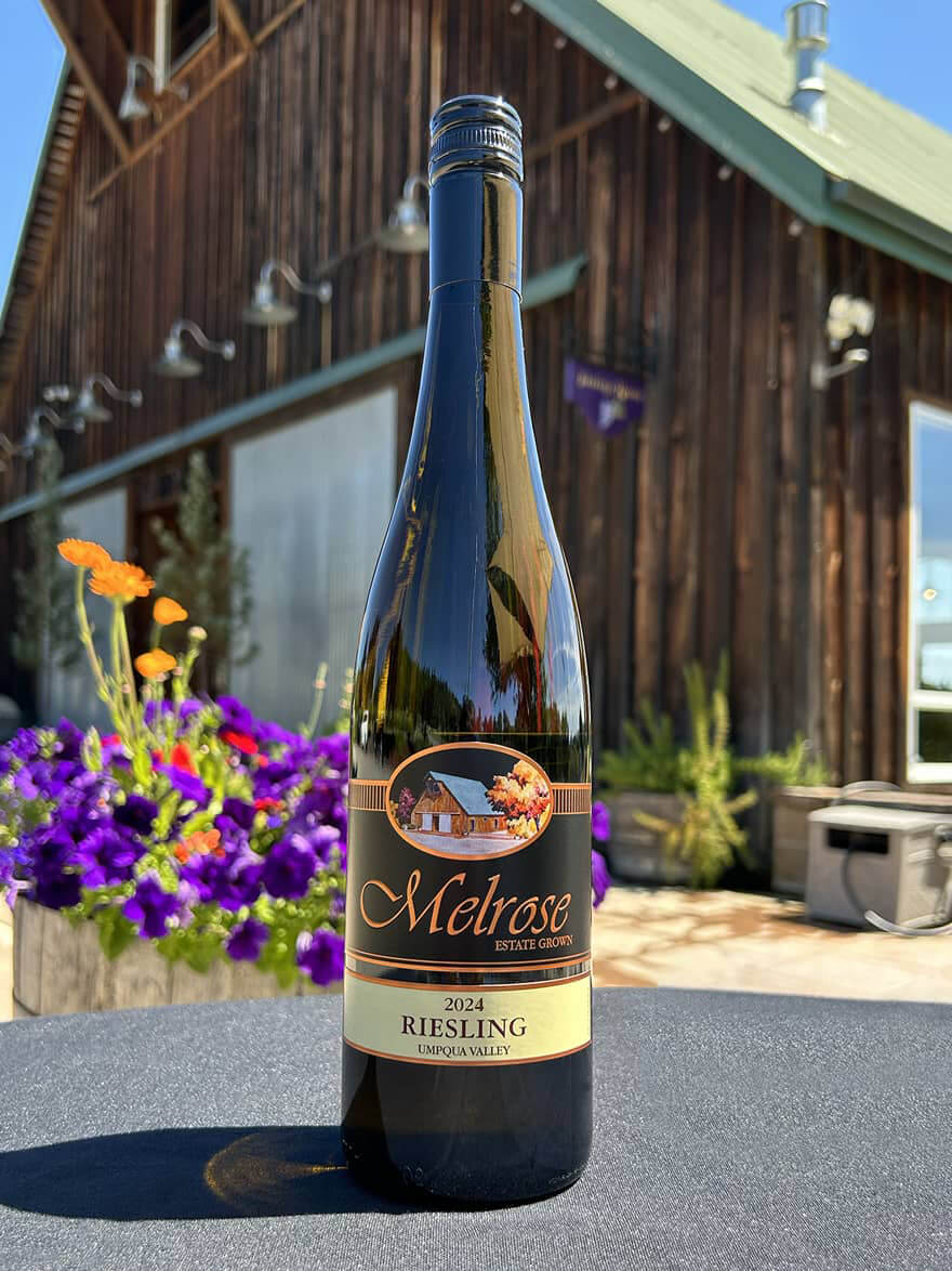 2024 Riesling bottle photographed in front of the Melrose Winery barn in Roseburg, OR